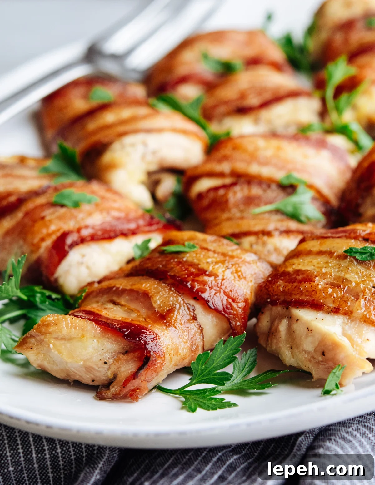 Bacon Wrapped Chicken Thighs served on a white oval platter.
