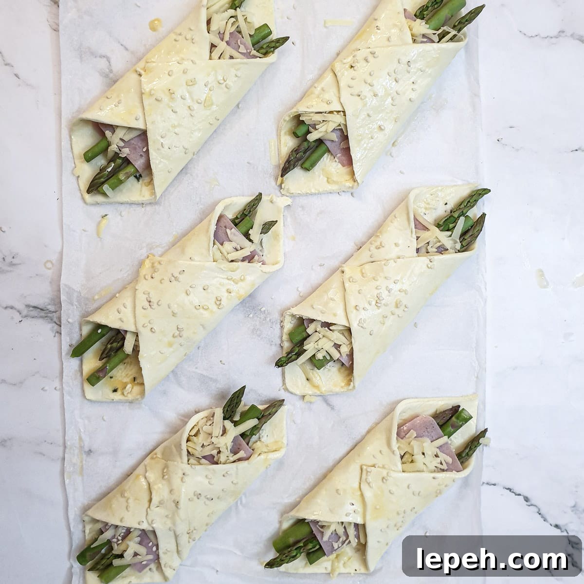 6 fully assembled asparagus and ham wraps.