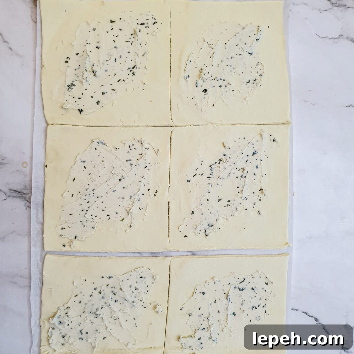 6 squares of puff pastry spread with garlic and herb flavoured cream cheese.