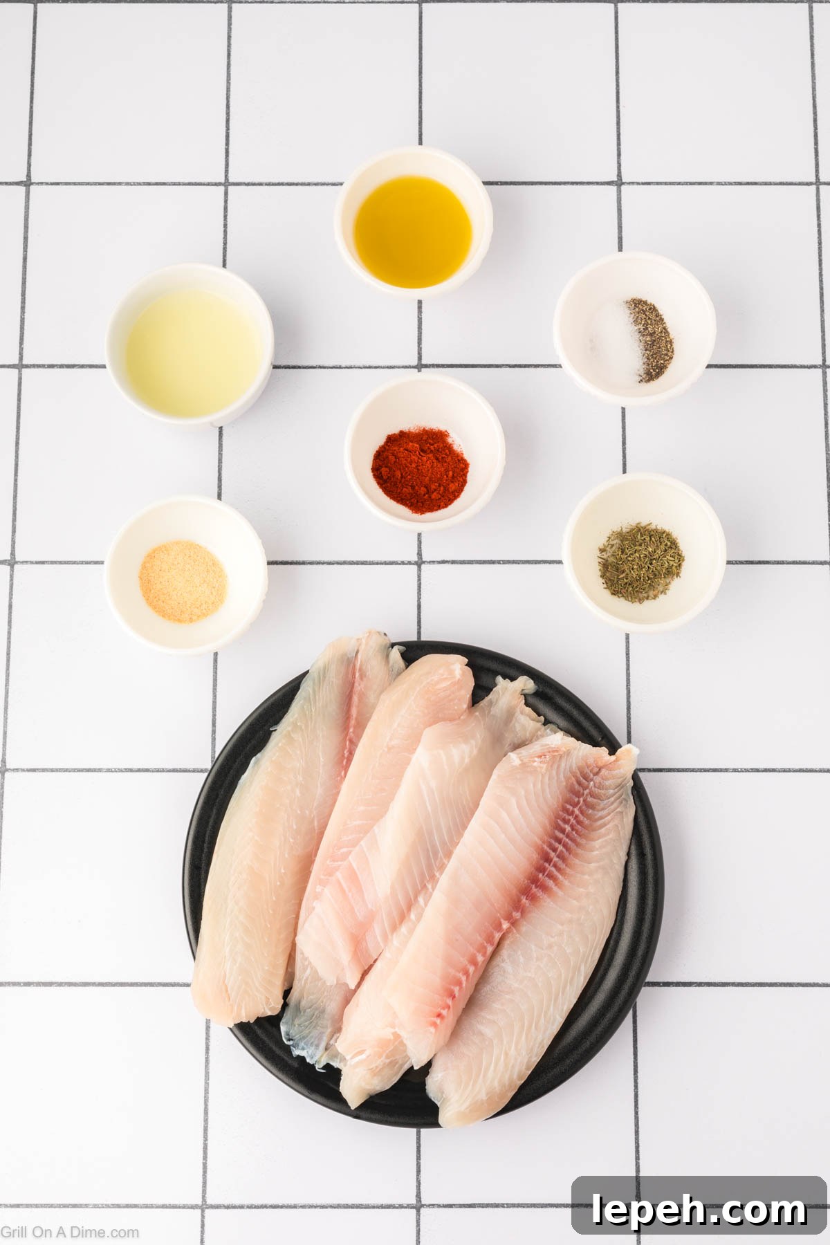 Grilled Tilapia Ingredients - tilapia, avocado oil, lemon, salt, pepper, garlic powder, paprika, thyme