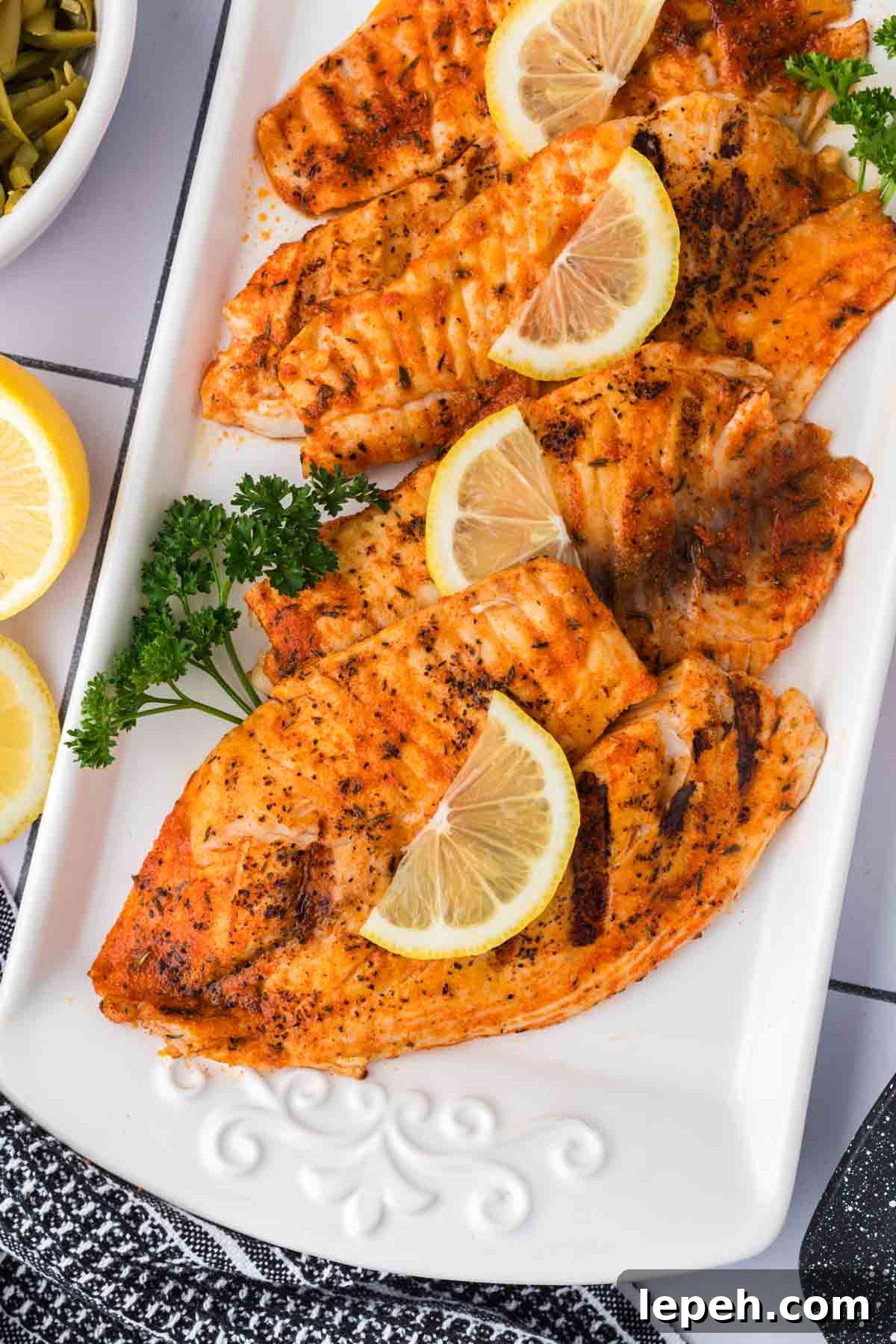 Grilled Tilapia stacked on a plate