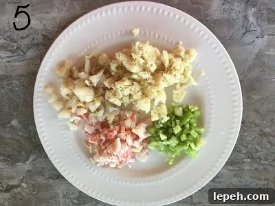 Crab meat, celery, fish and bread keep aside in a plate.