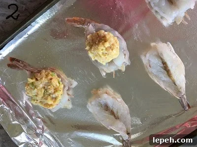 Stuffing placed on the butterfly shrimp.