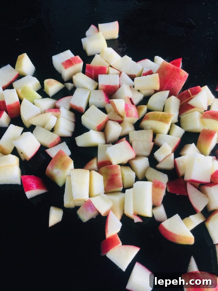 diced apples on the griddle before cooking