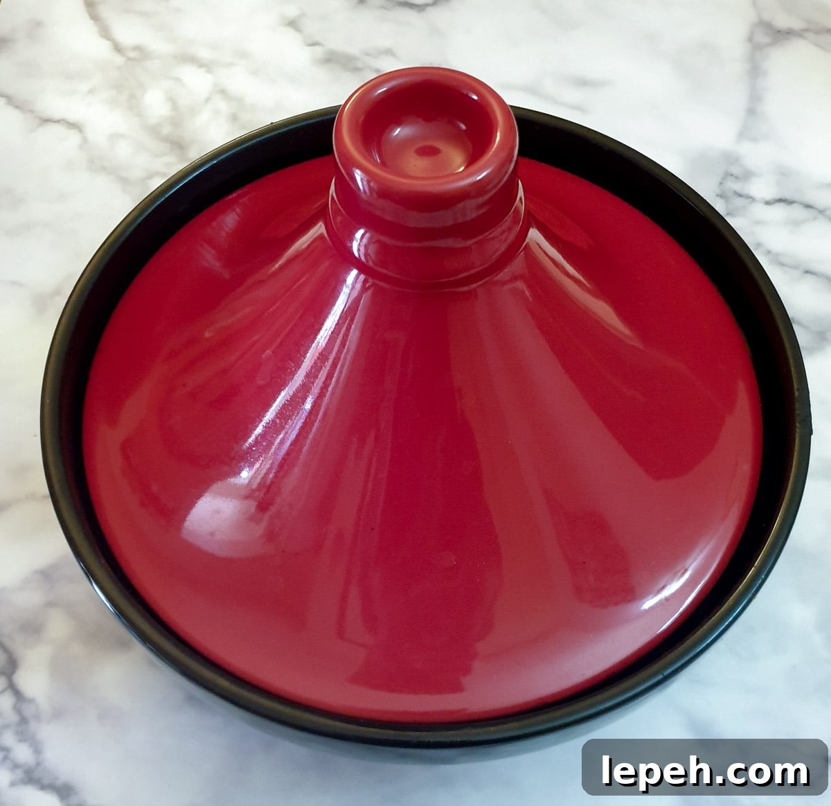 Overhead shot of a tagine with a red-domed lid.