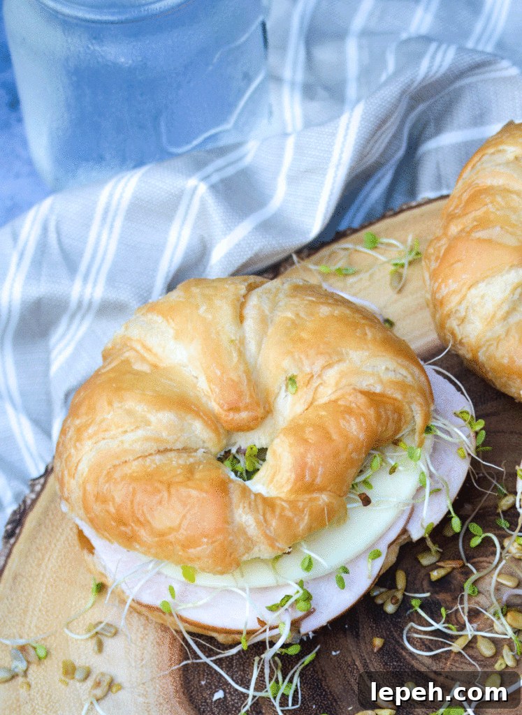 a nutty bird sandwich shown on a wooden cutting board