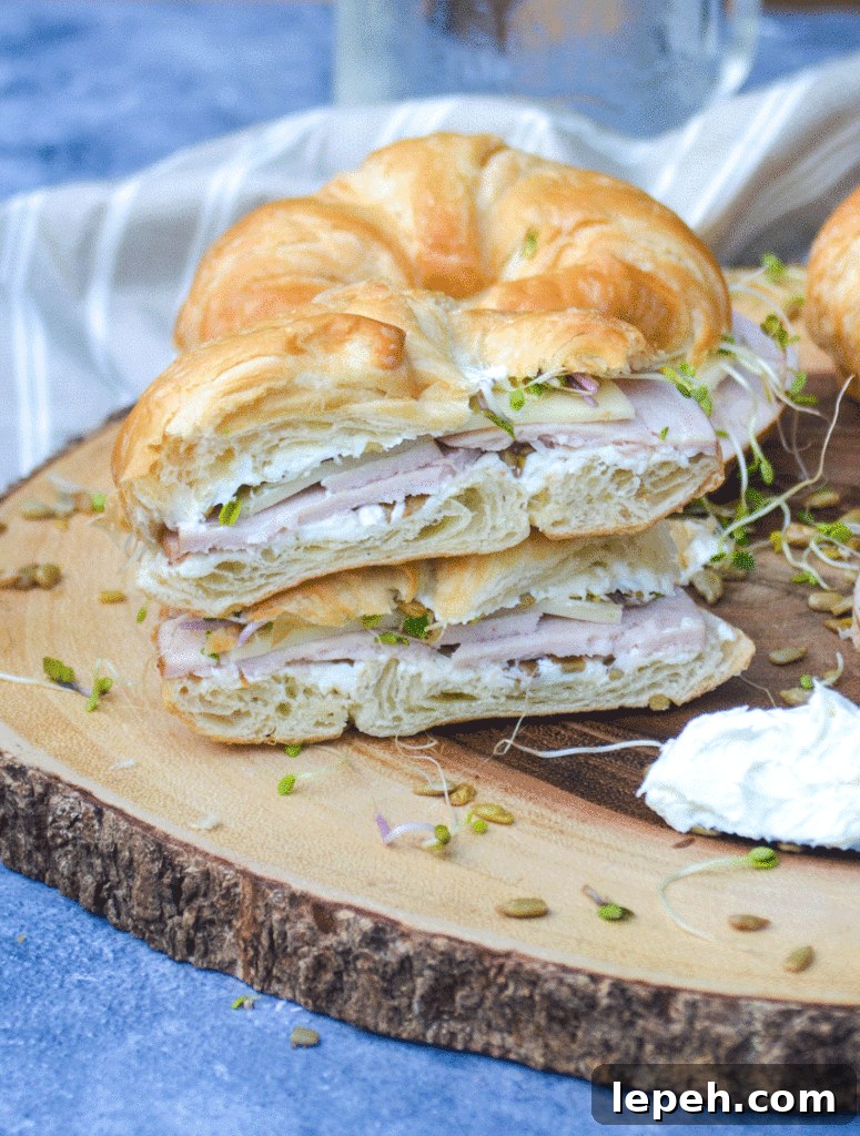 a nutty bird sandwich cut in half to reveal the filling layered inside