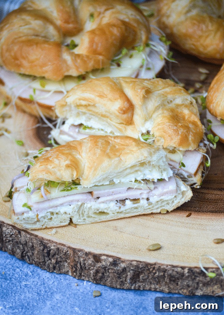 a nutty bird sandwich cut in half to reveal the filling layered inside