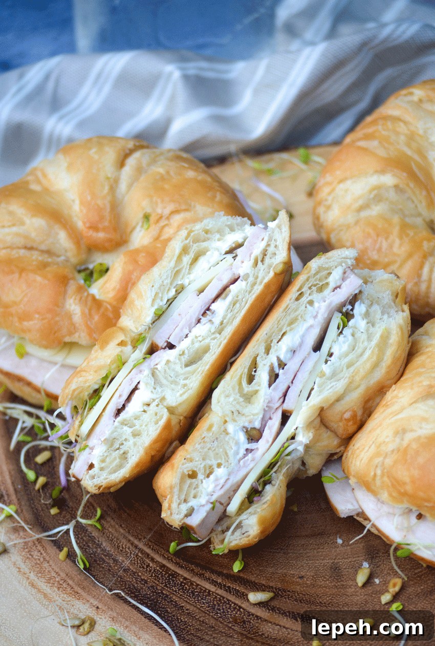 a nutty bird sandwich cut in half to reveal the filling layered inside