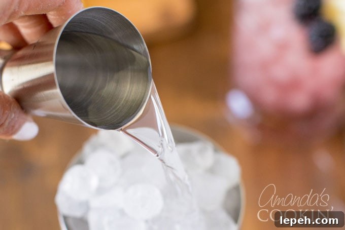 adding gin to cocktail shaker