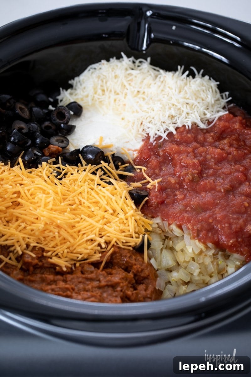 chili, salsa, cheese, olives and onions in slow cooker