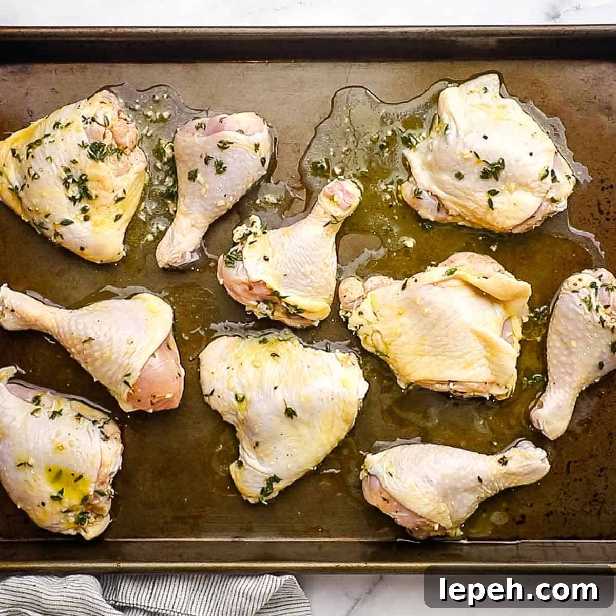 chicken pieces laid out on a baking sheet