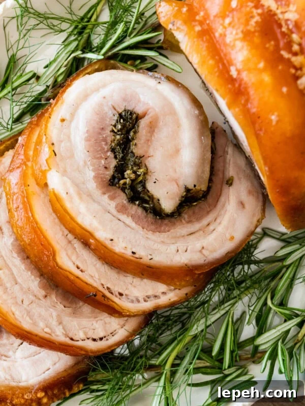 Beautiful porchetta roast with crispy skin and juicy interior.