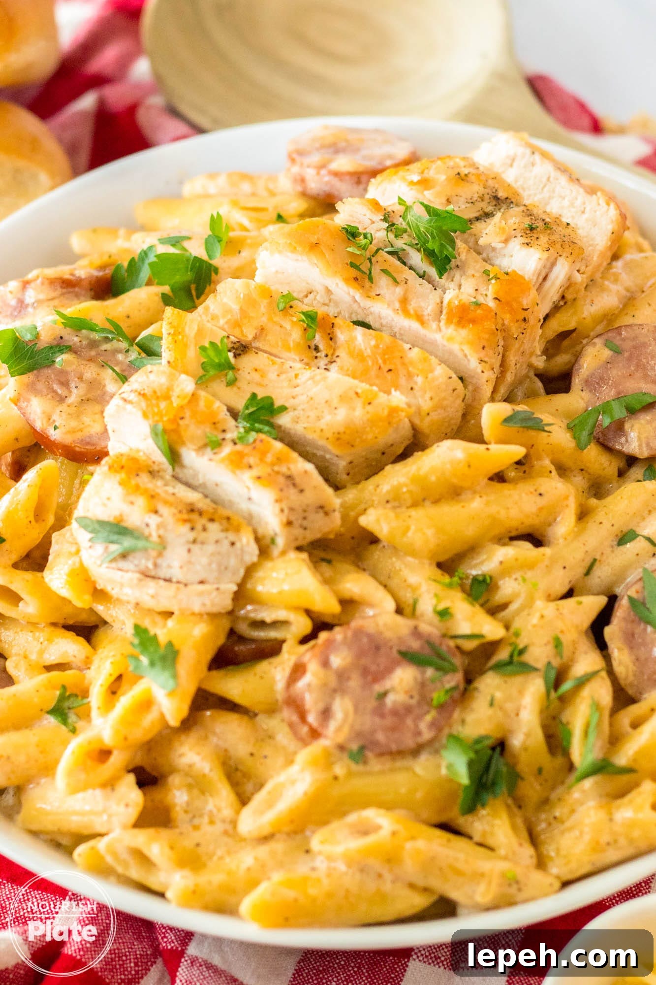Cajun Chicken Alfredo made with penne pasta, and sliced chicken, plated.
