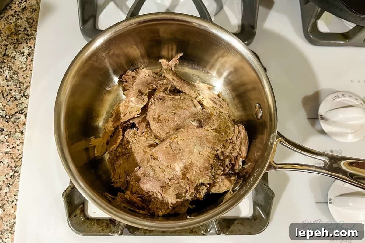 Thawed pork in small saucepan on stove