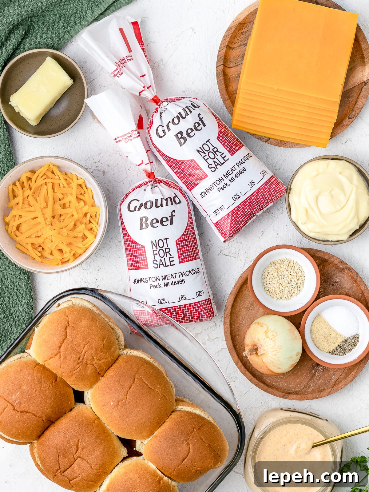 Ingredients needed to make cheesy ground beef sliders with a sriracha aioli.