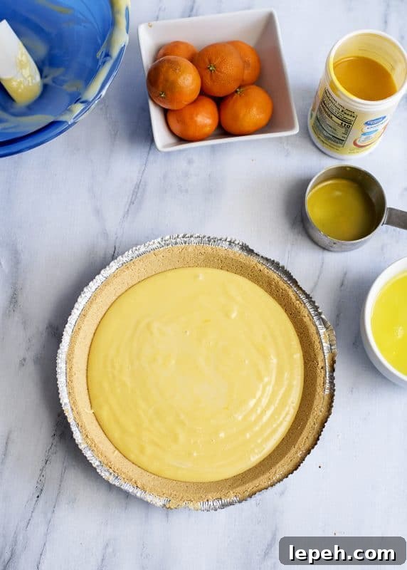 Mix together condensed milk, juice, and egg yolks in a mixing bowl and then pour into the shell.