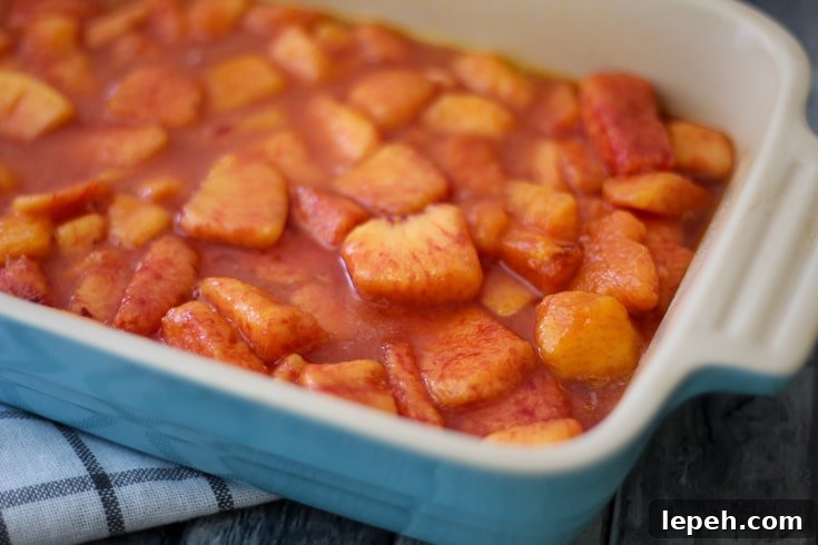 Chopped peaches with sugar and flour in a pan.