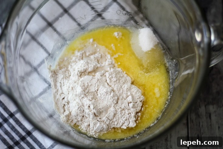 Melted butter, sugar, and flour in a glassbowl.