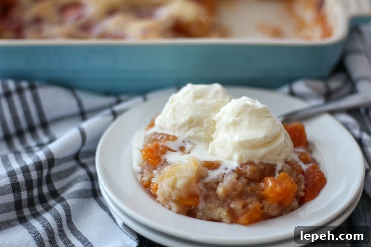 Peach Cobbler with ice cram melting over the top.