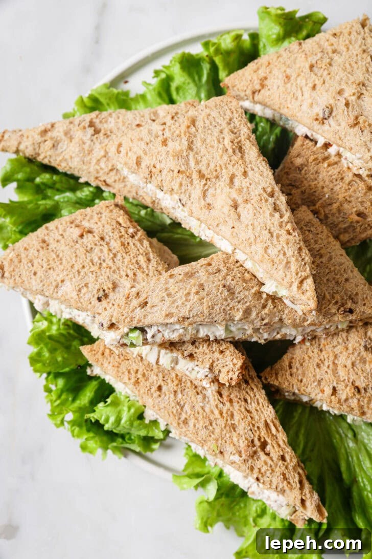 Top view of a platter of Chicken Mayo Sandwiches on a bed of lettuce.