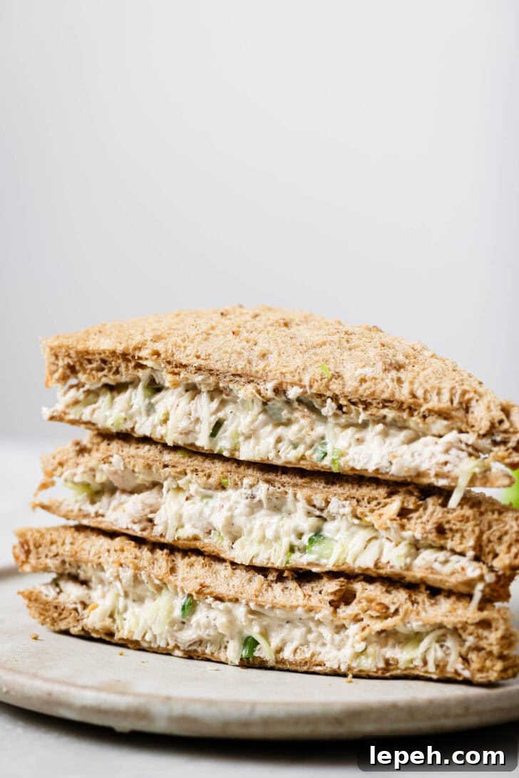 Close up of a stack of Chicken Mayo Sandwiches on a plate.