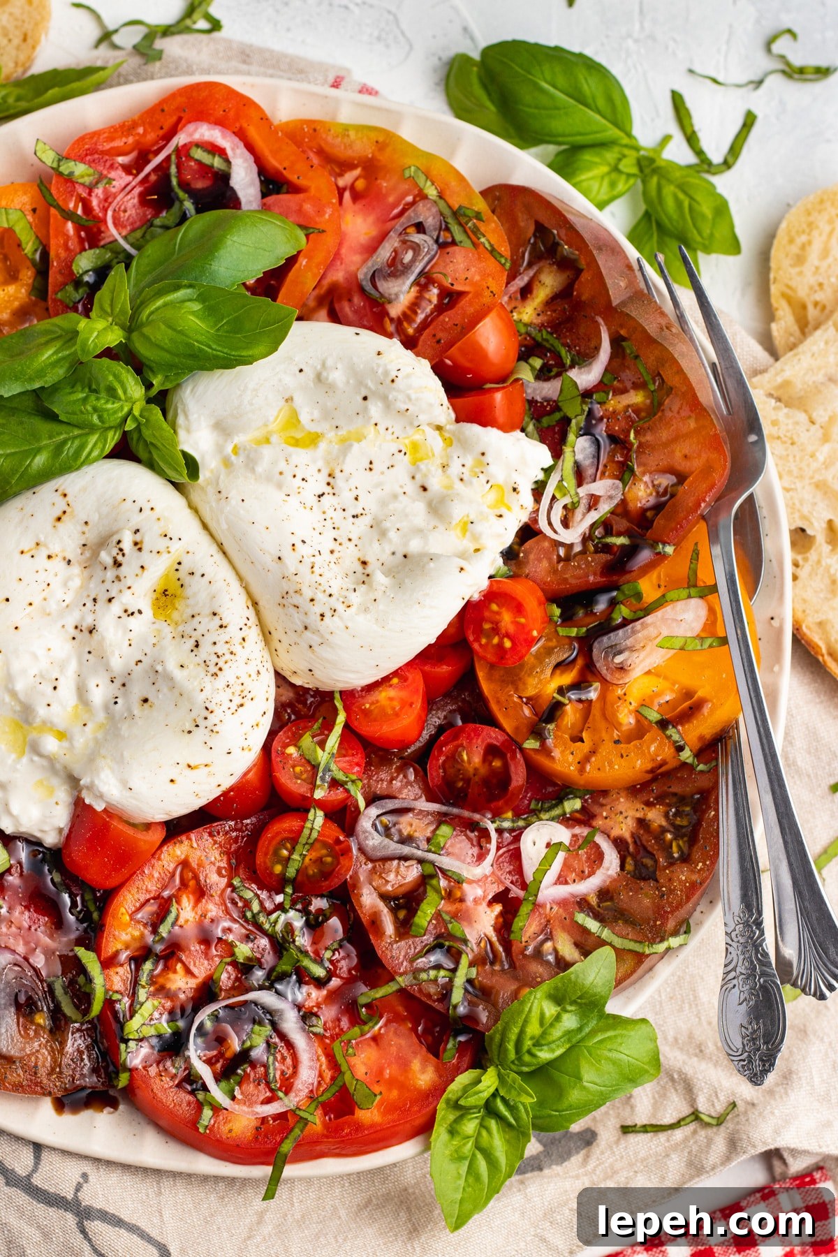 Picture of a plate with burrata caprese. 
