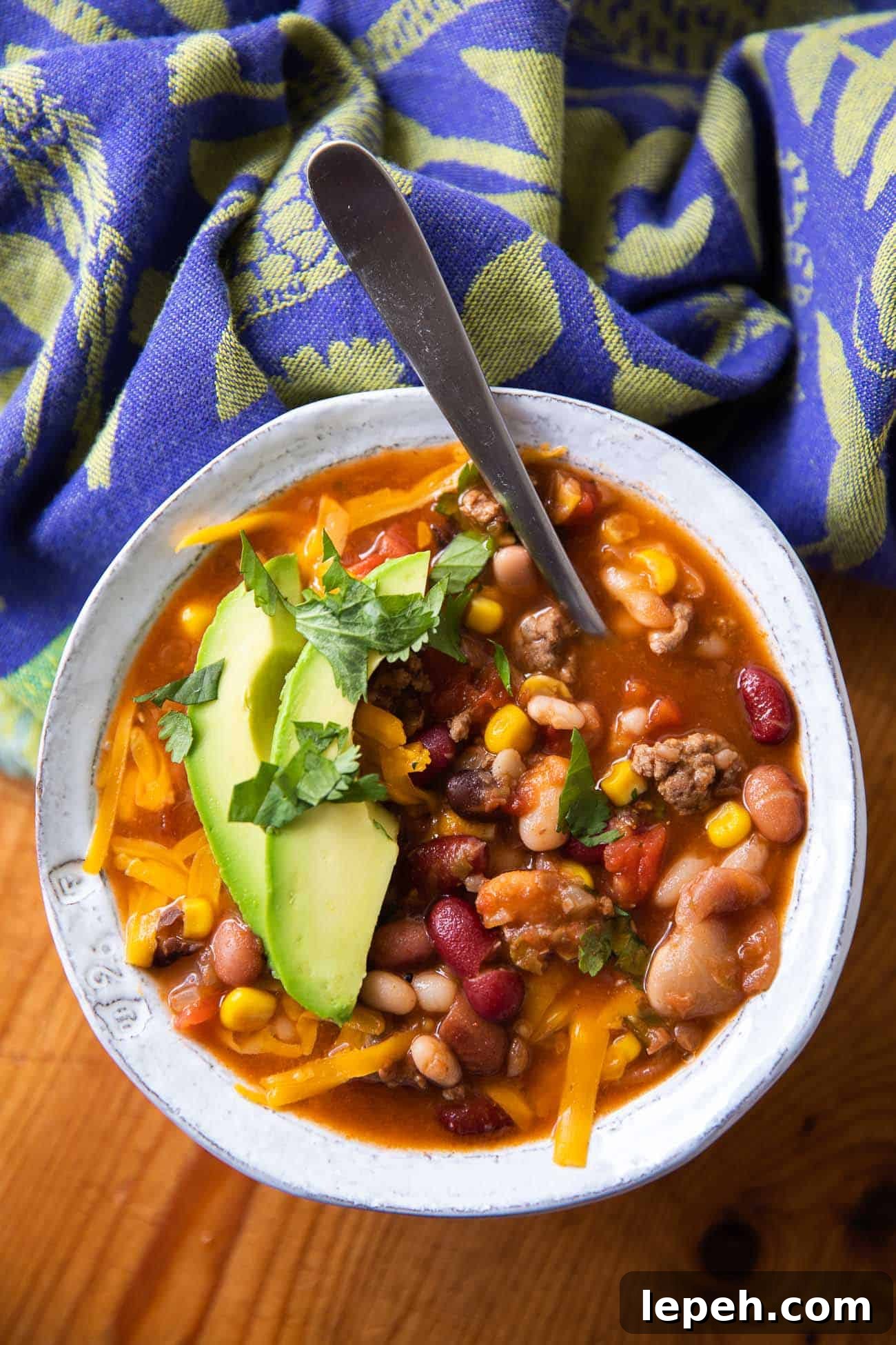 overhead photo of soup with beans, meat and cheese