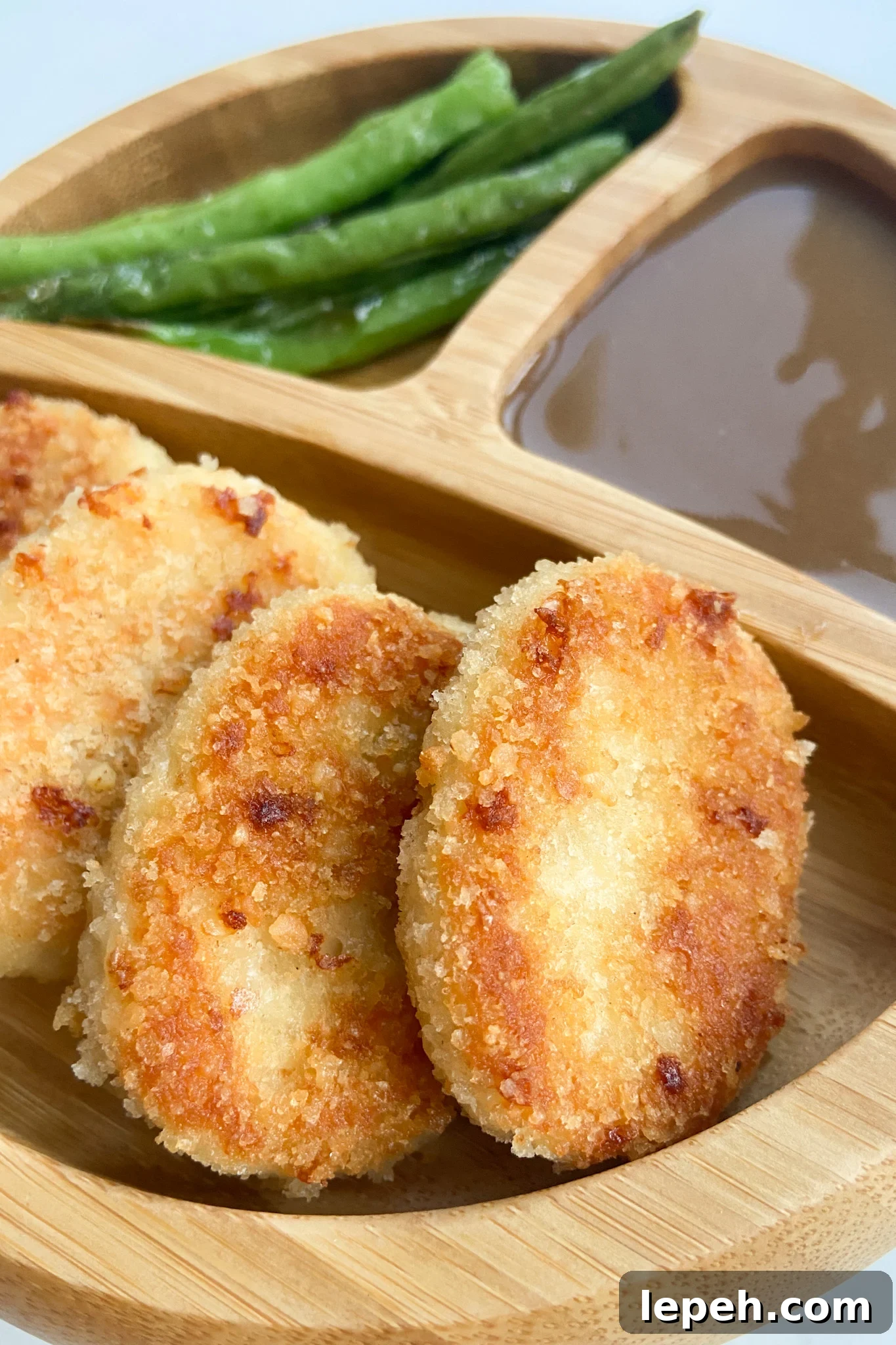 Leftover turkey nuggets served with a side of gravy and green beans