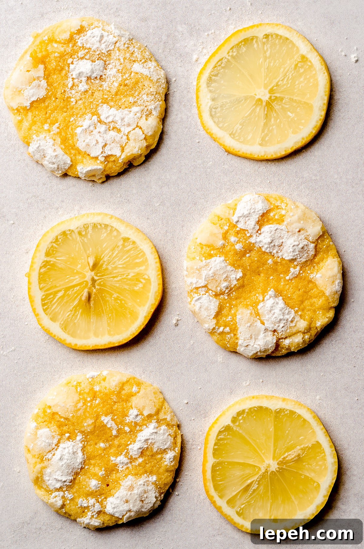 lemon crinkle cookies alternating with slices of lemon