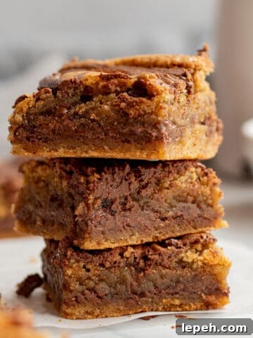 stack of 3 nutella blondies with white bowl and carafe in background