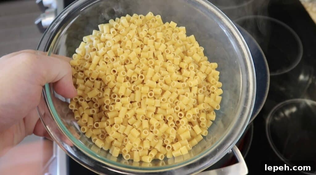 Adding ditalini pasta to salted boiling water