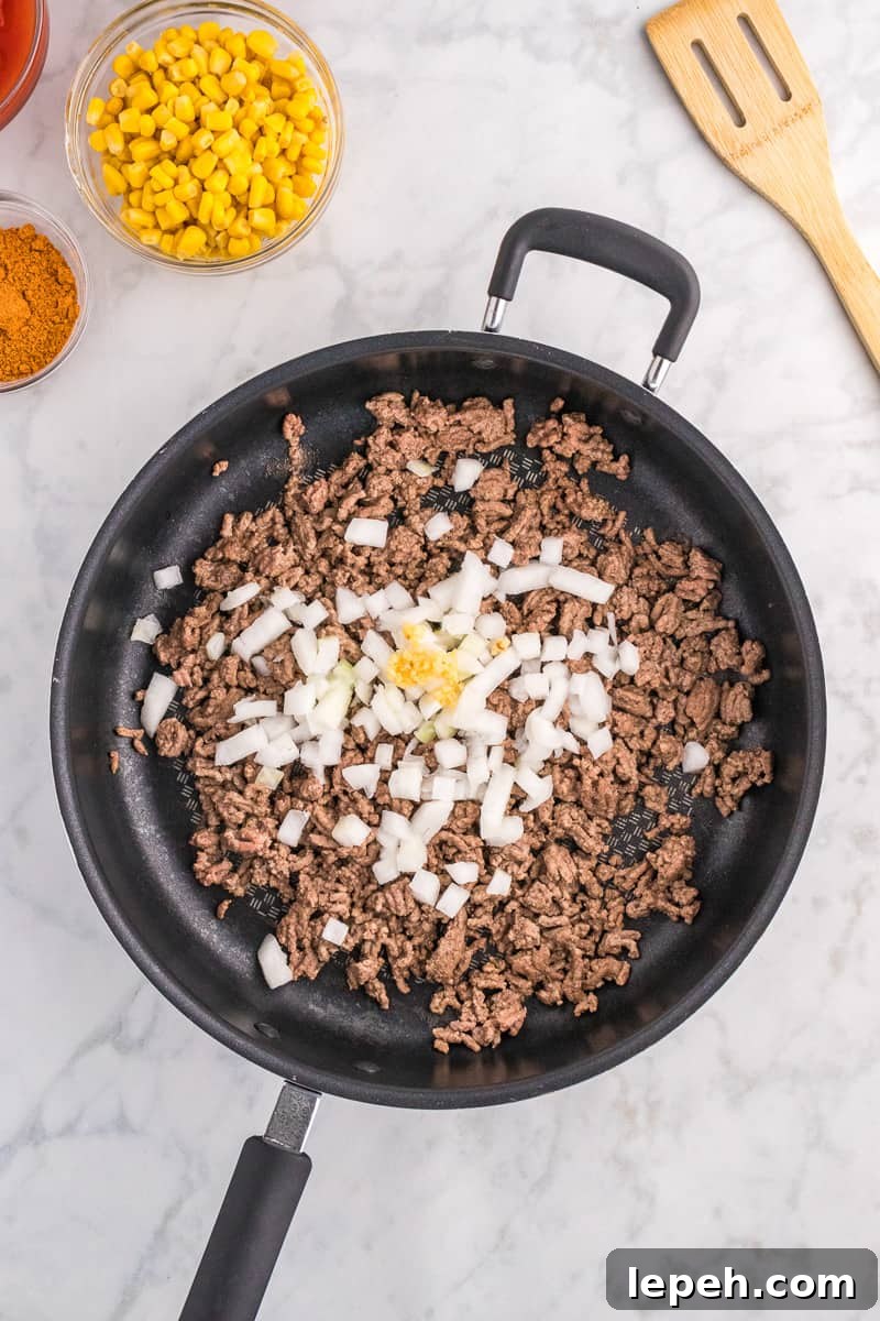 Ground beef, onions and garlic in skillet.