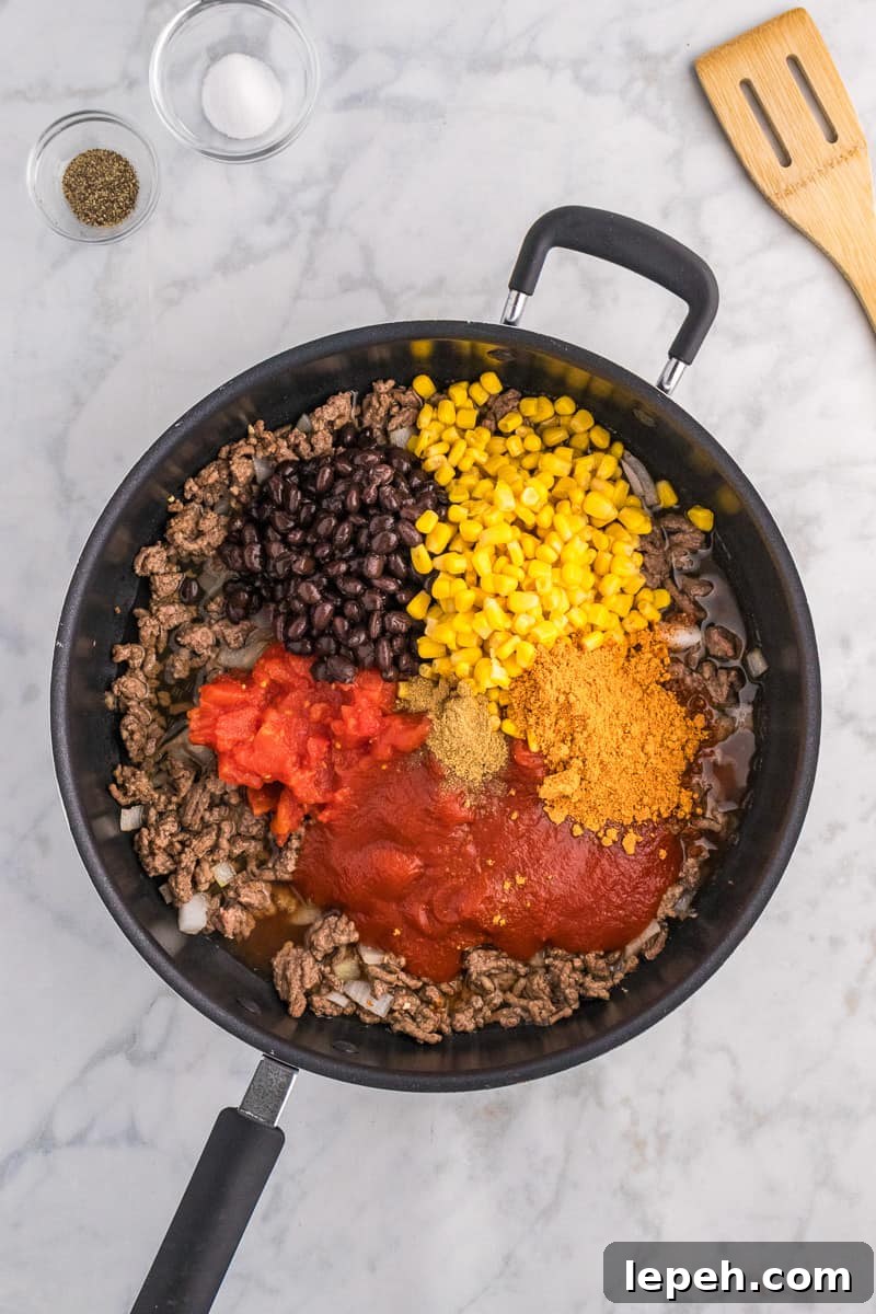 Remaining ingredients are added to beef in skillet.