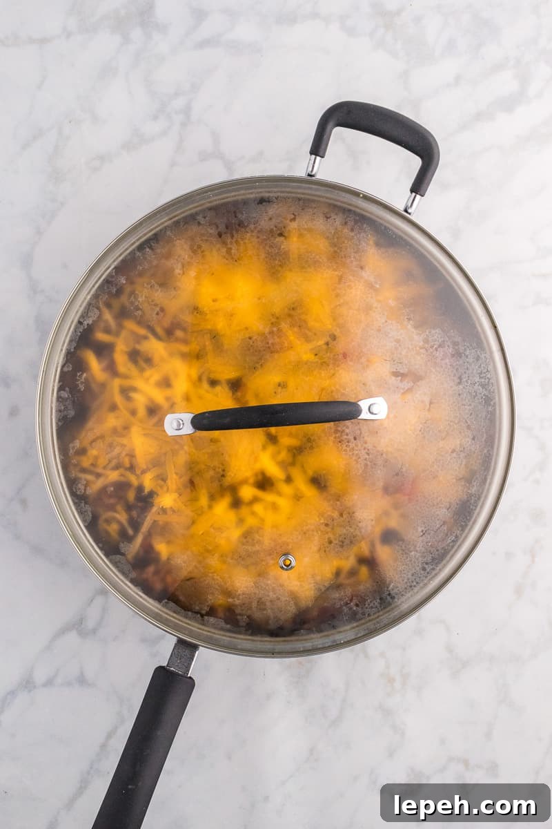 Lid is place on top of taco spaghetti to melt the cheese.