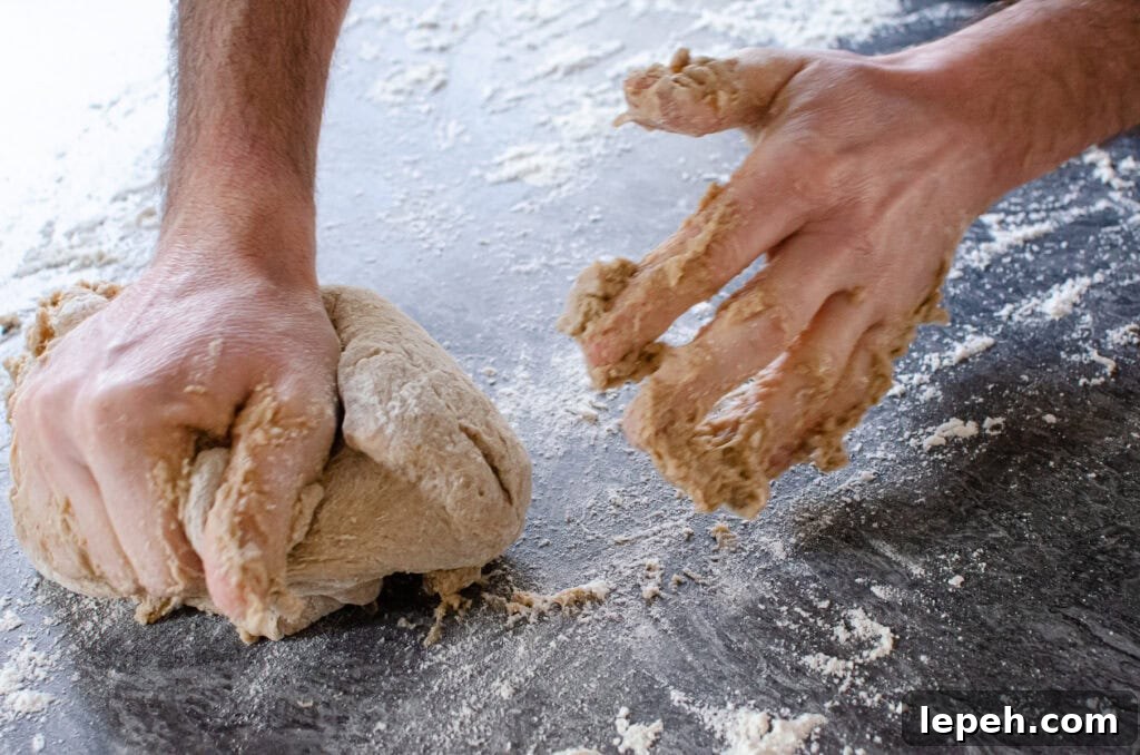 Kneading the dough on a floured surface to make our hot cross buns