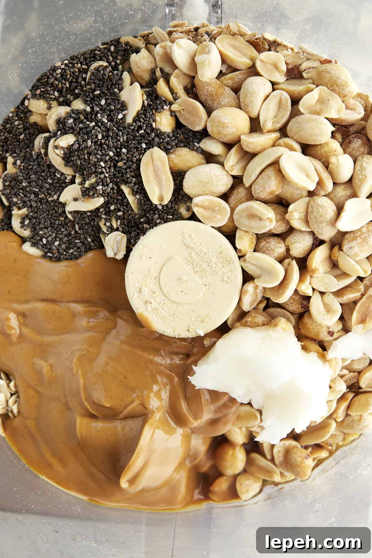 Peanuts, chia seeds, peanut butter, and coconut oil in a food processor.