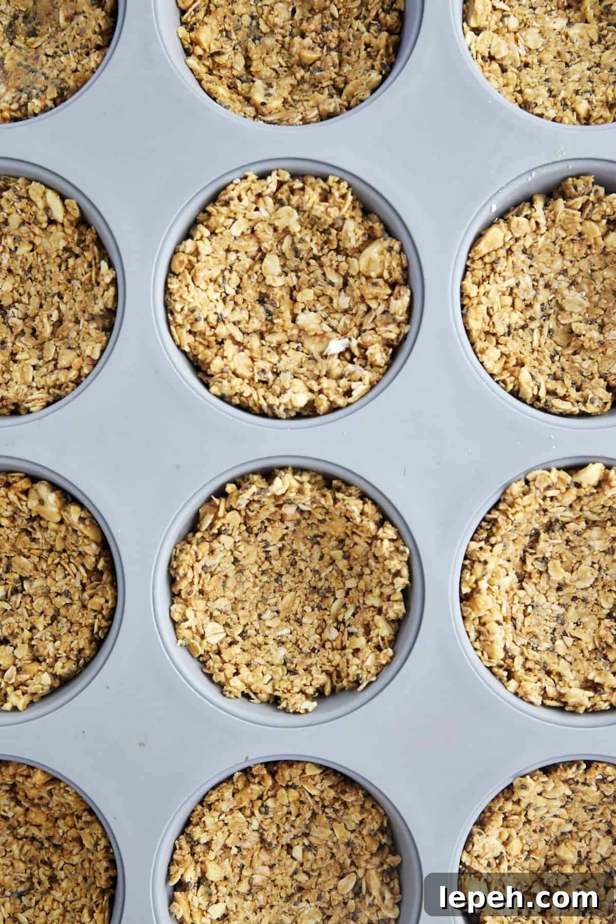 An oat mixture in a muffin pan. 