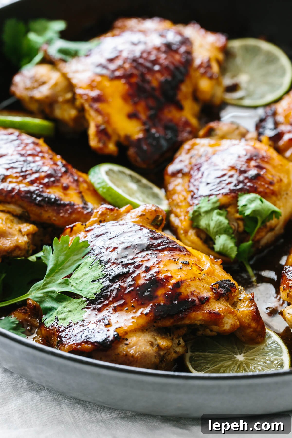 Close up photo of cilantro lime chicken thigh in a pan.