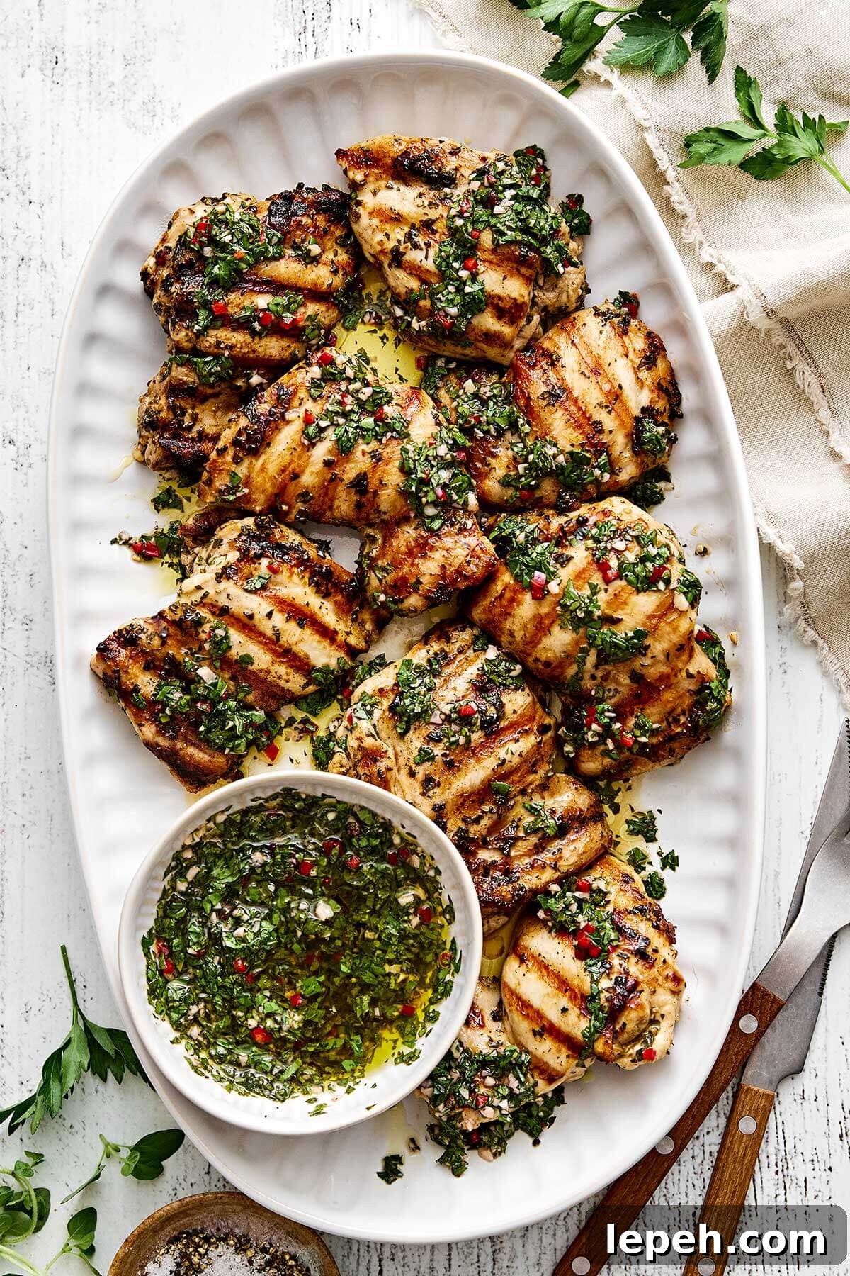 A plater of grilled chimichurri chicken thighs.