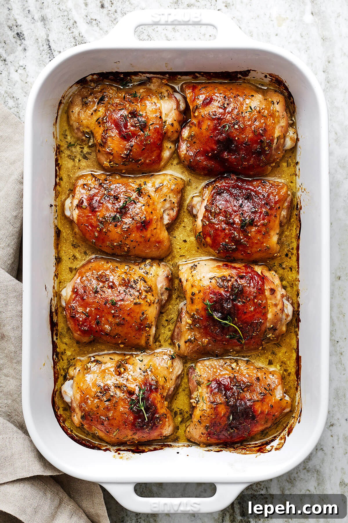 A casserole dish filled with honey mustard chicken thighs