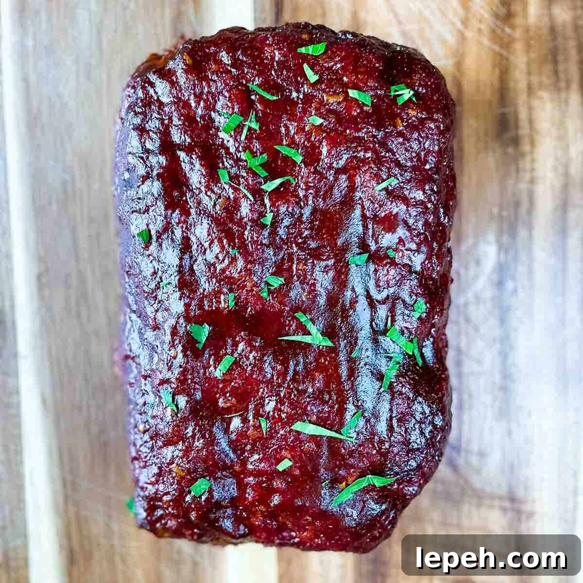 The smoked meatloaf garnished with fresh parsley.