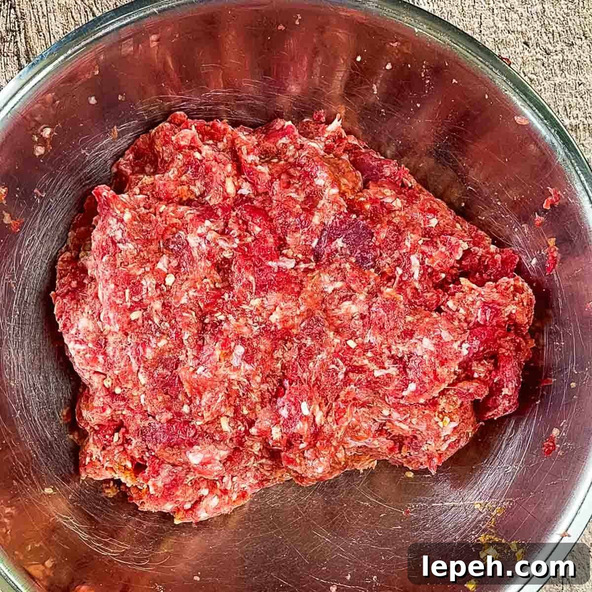 The ingredients for the meatloaf combined in the large mixing bowl.