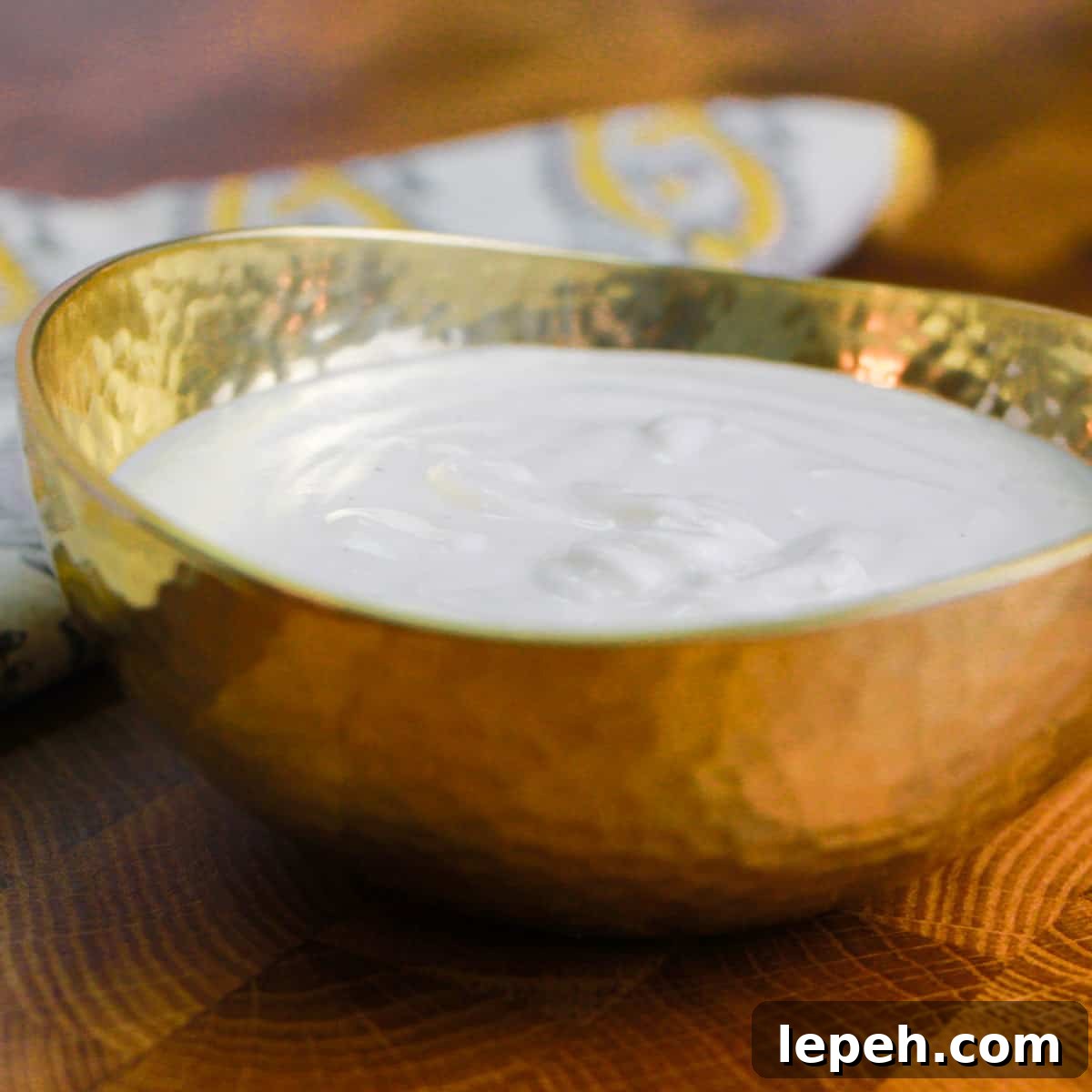 photo of a small brass bowl filled with cashew cream