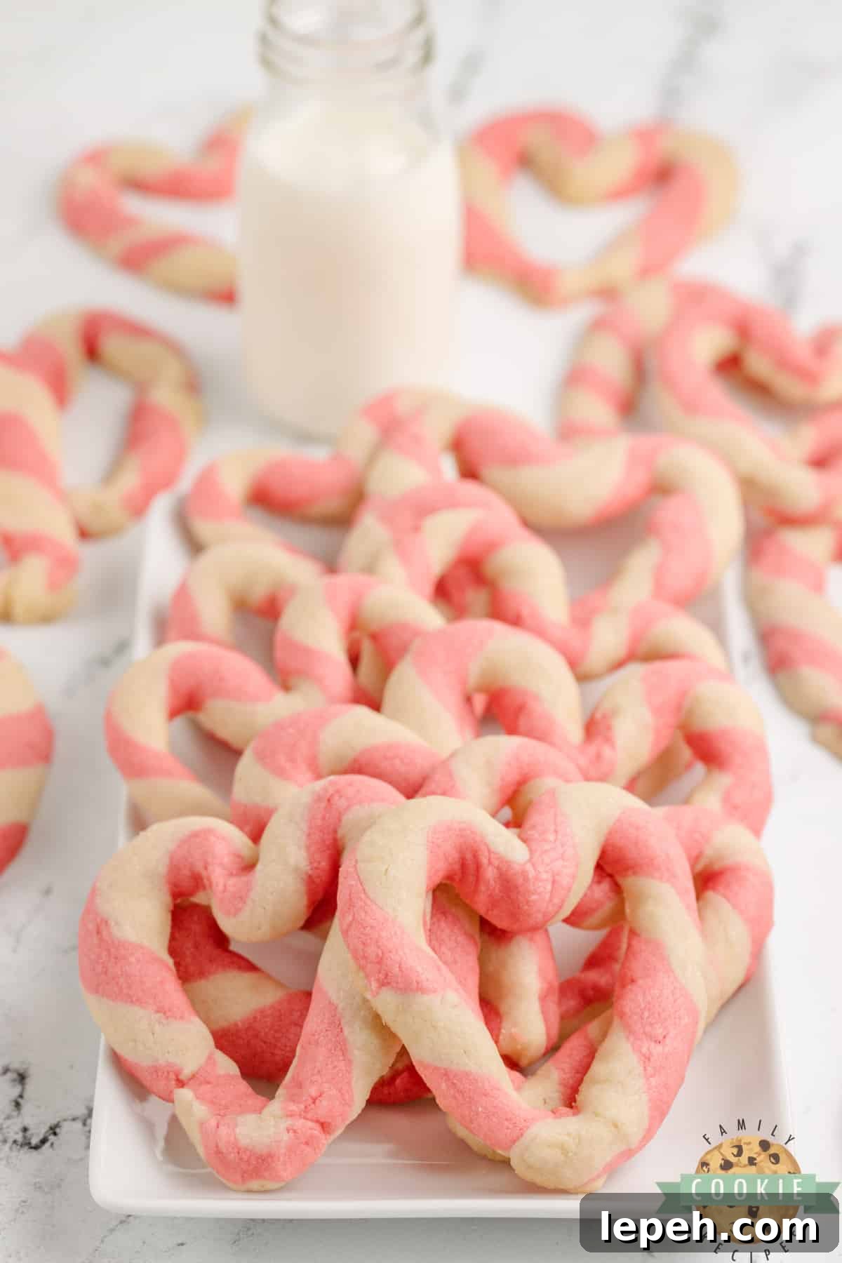 Braided Sweetheart Cookies are simple sugar cookies formed into pink and white striped hearts. These heart-shaped cookies are easy to make and are so pretty, you don't even need frosting!