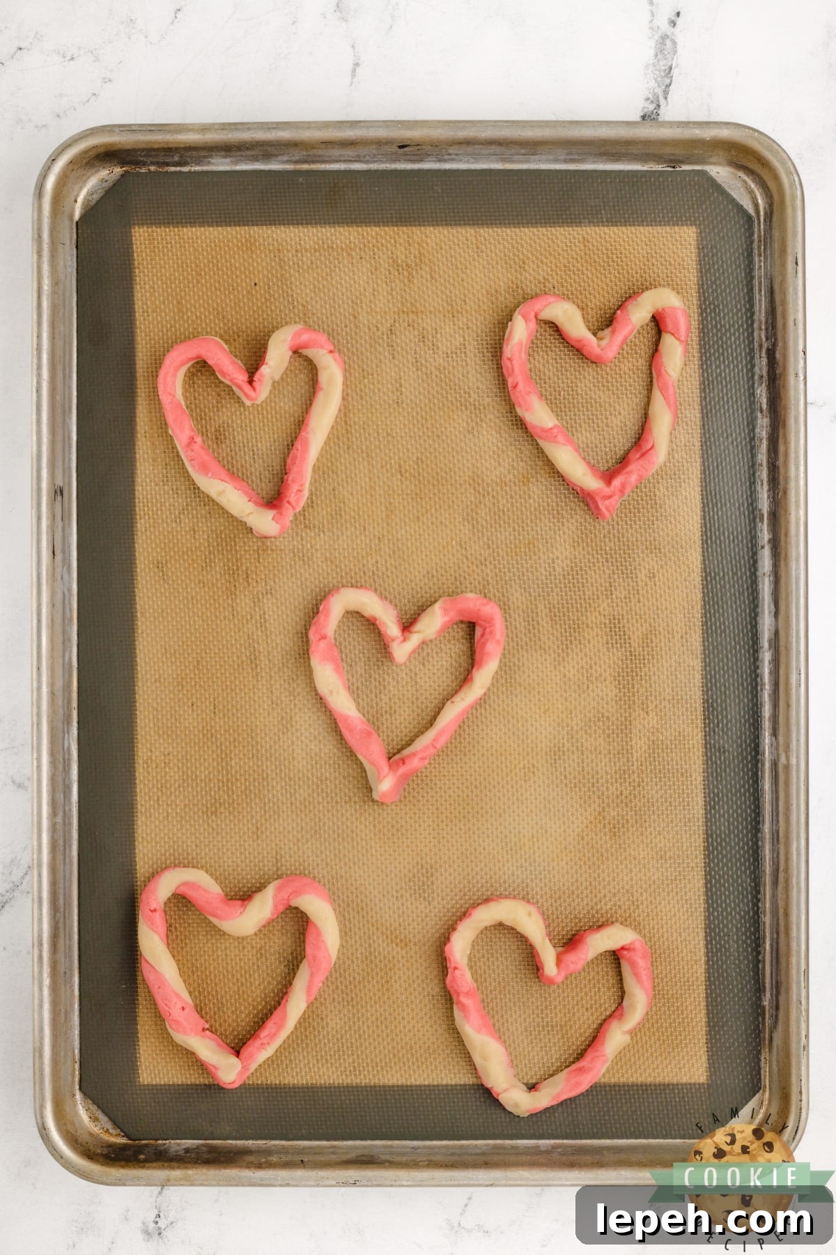 Pink and white dough twisted into a heart shape.