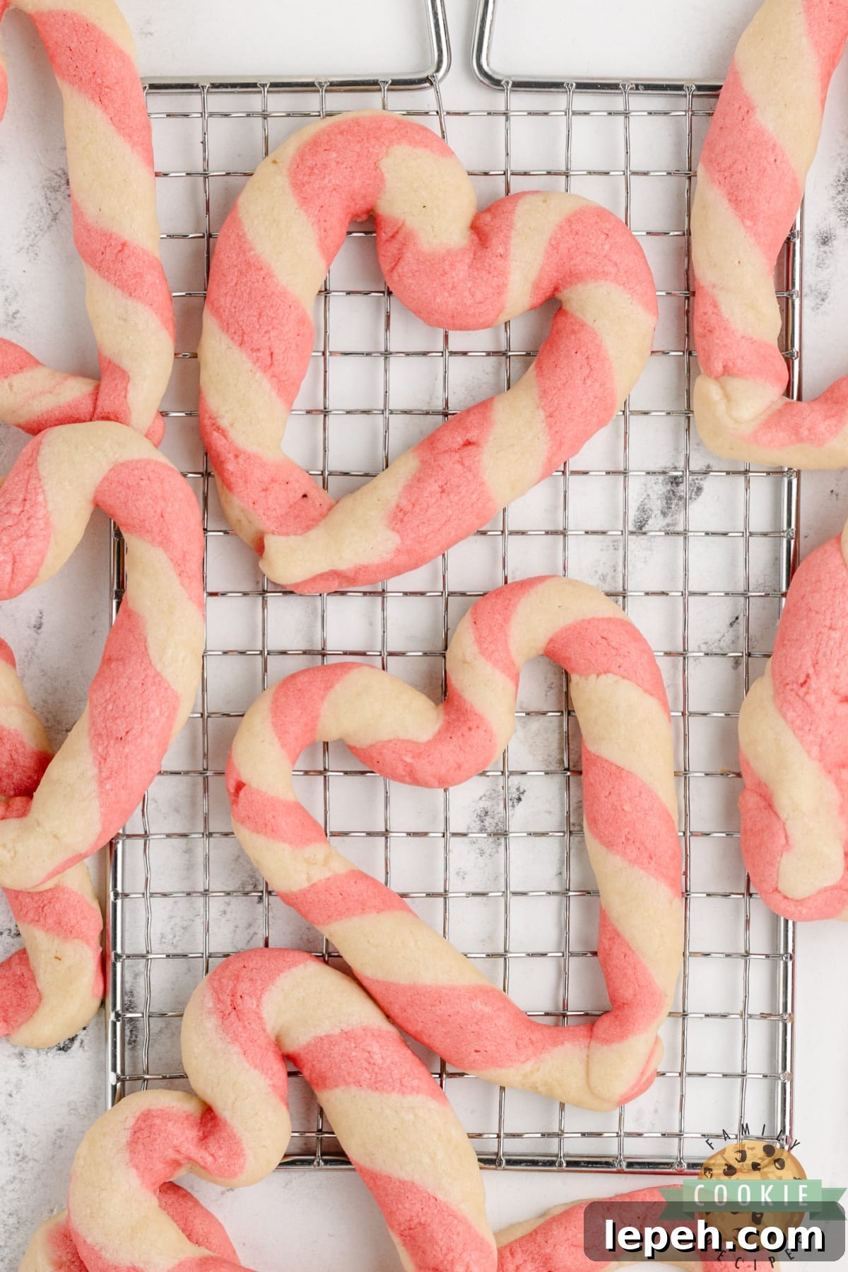 Braided Sweetheart Cookies are simple sugar cookies formed into pink and white striped hearts. These heart-shaped cookies are easy to make and are so pretty, you don't even need frosting!