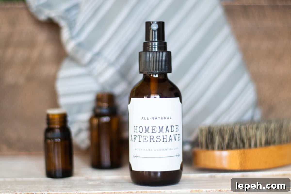 A bottle of homemade aftershave with a blue towel behind it and a brush next to it.