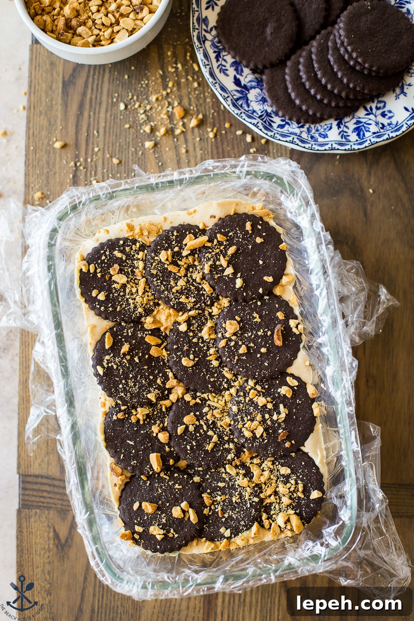 Overhead photo of a loaf pan of chocolate wafers and chopped peanuts