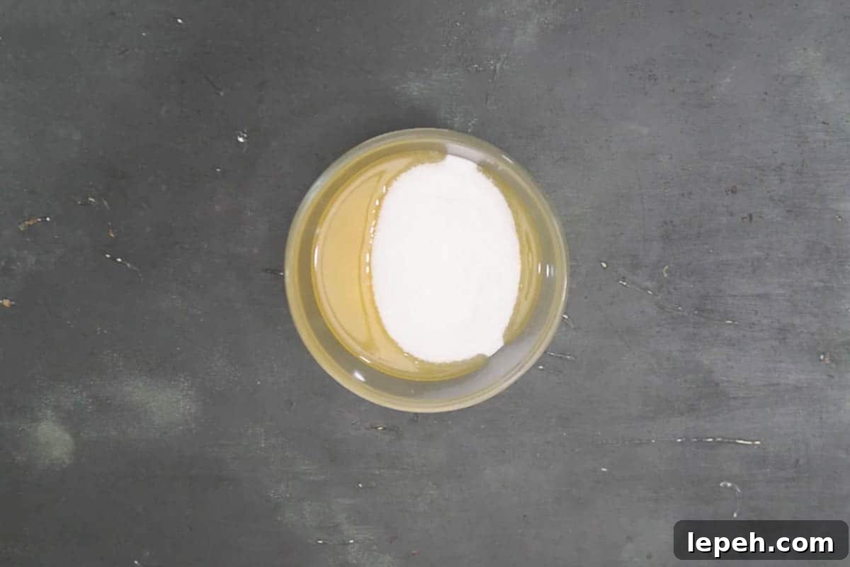 Vegetable oil, melted butter, and sugar mixed in another bowl.